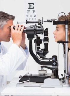 Woman doing eye test with optometrist in medical office